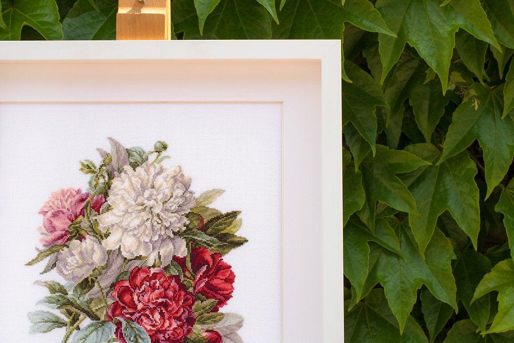 Piones B2355L Counted Cross-Stitch Kit featuring colorful threads, canvas, and needle for crafting.